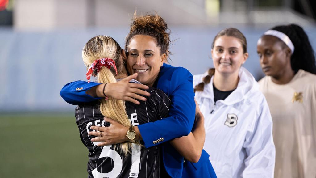 Head Coach Jessica Silva hugs MacKenzie George after BKFC's 2-0 victory over Dallas Trinity FC