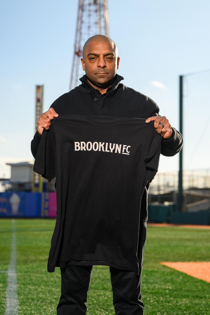 Marlon LeBlanc holds a Brooklyn FC shirt on the field at Maimonides Park in Coney Island.