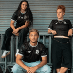Three young people posing on a modern background wearing brooklyn fc merch