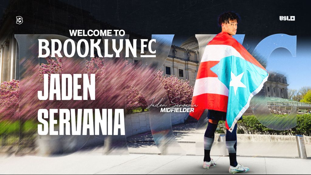 Midfielder Jaden Servania stands outside the Brooklyn Museum draped in a Puerto Rico flag, welcoming him to Brooklyn FC ahead of the club’s inaugural season.