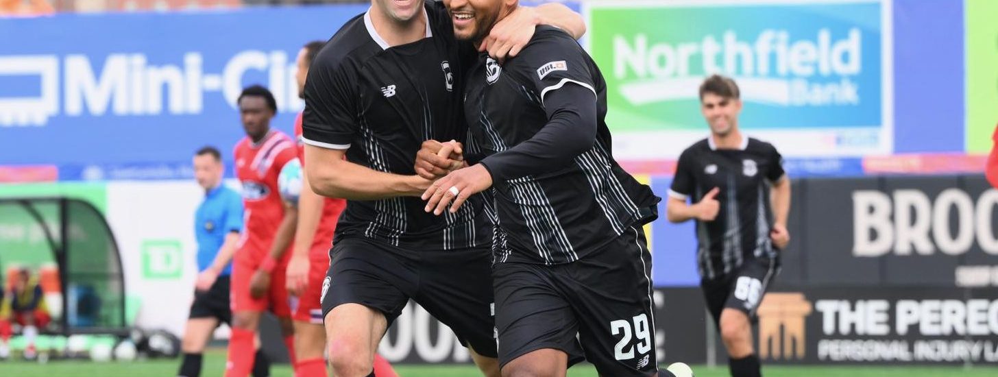 Juan Carlos Obregón Jr. and Peter Mangione celebrates together.