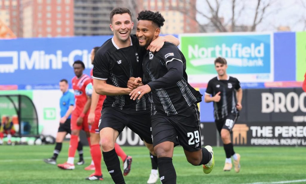 Juan Carlos Obregón Jr. and Peter Mangione celebrates together.