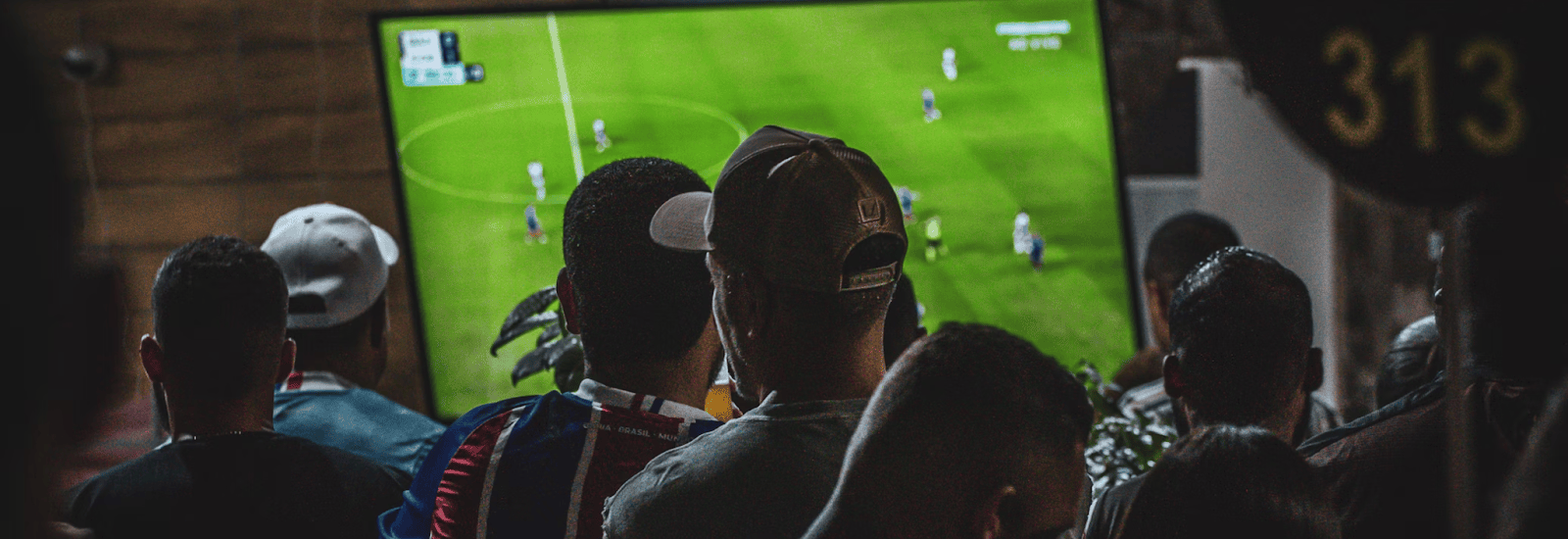 Friends view a Brooklyn FC match at a local bar